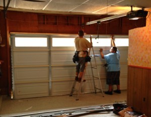 Two technicians repairing Garage Door in Richardson, TX